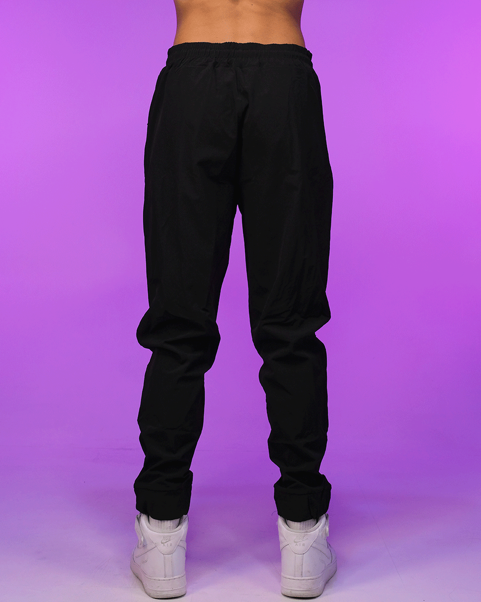 Black unisex joggers with drawstring waist, tapered legs, and elastic ankle cuffs