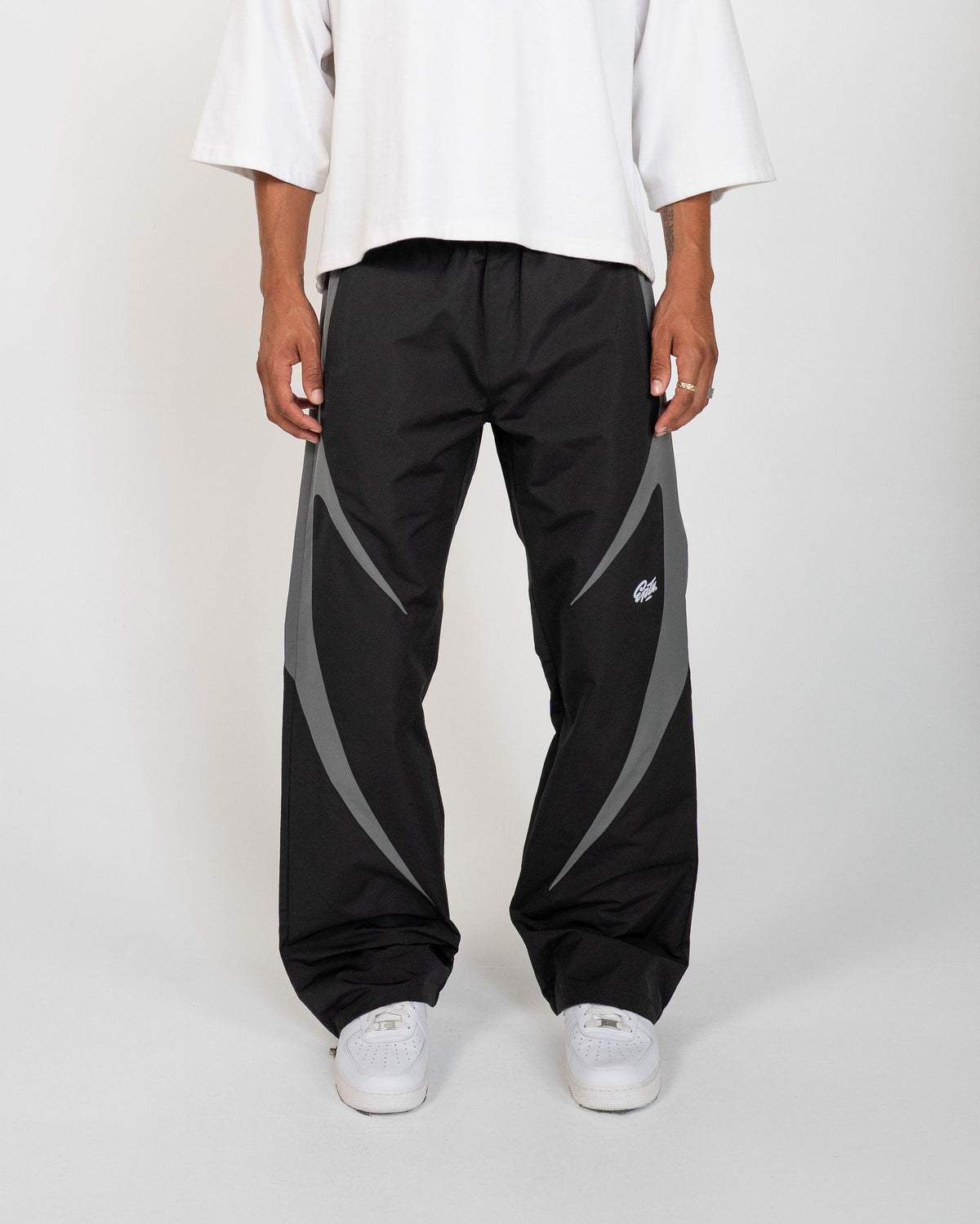 Black Blade Men's Reflective Pants, black wide-leg with gray blade panels, front view on model