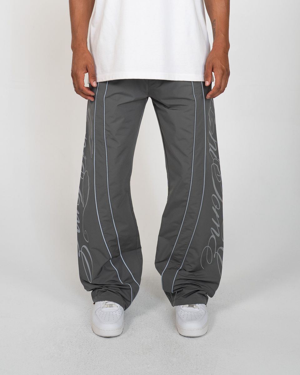 Charcoal Monogram Men's Pants, gray wide-leg with script monogram down the legs, front view on model