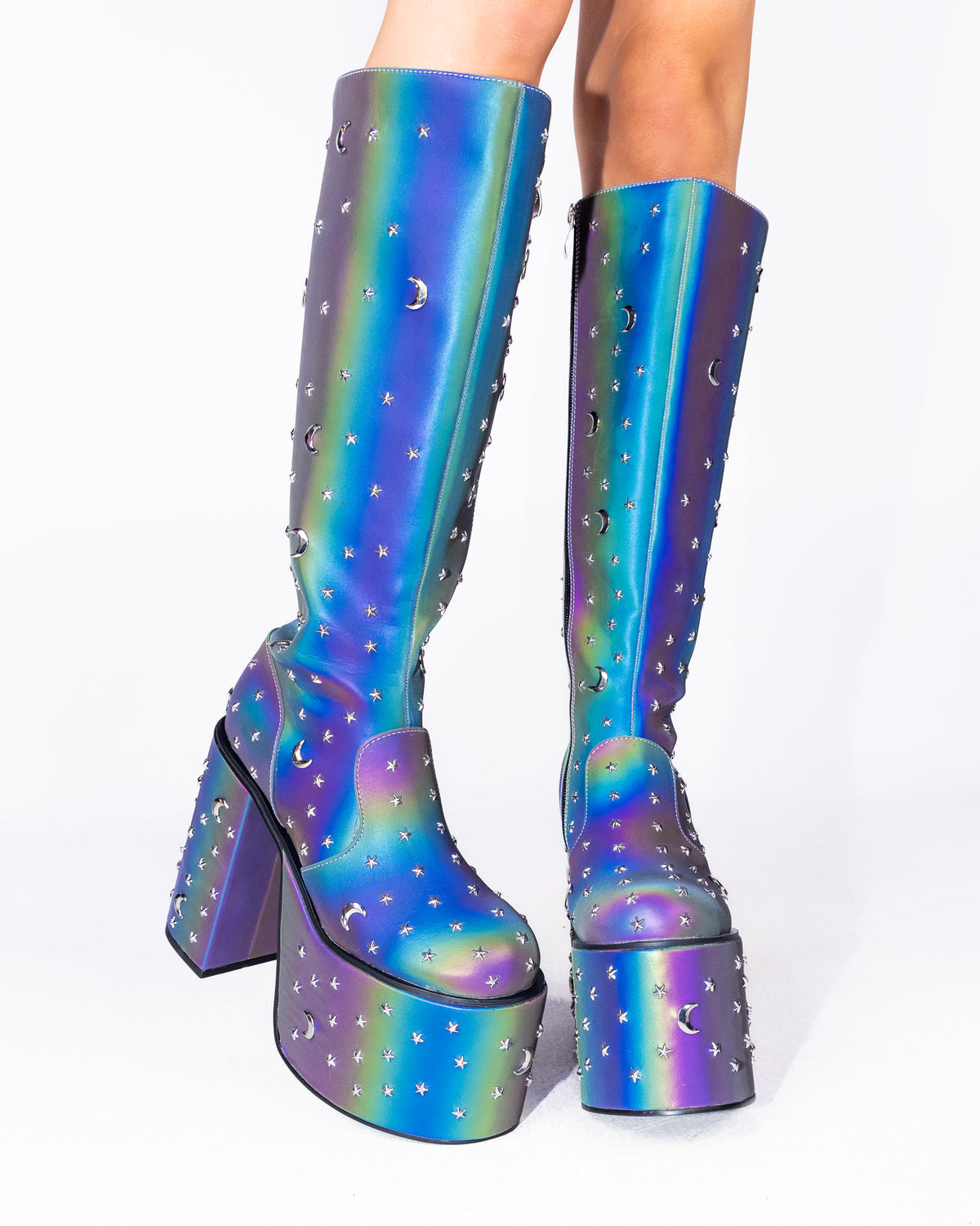 Milky Way reflective chunky platform knee-high boots, iridescent rainbow with star and moon studs, front view