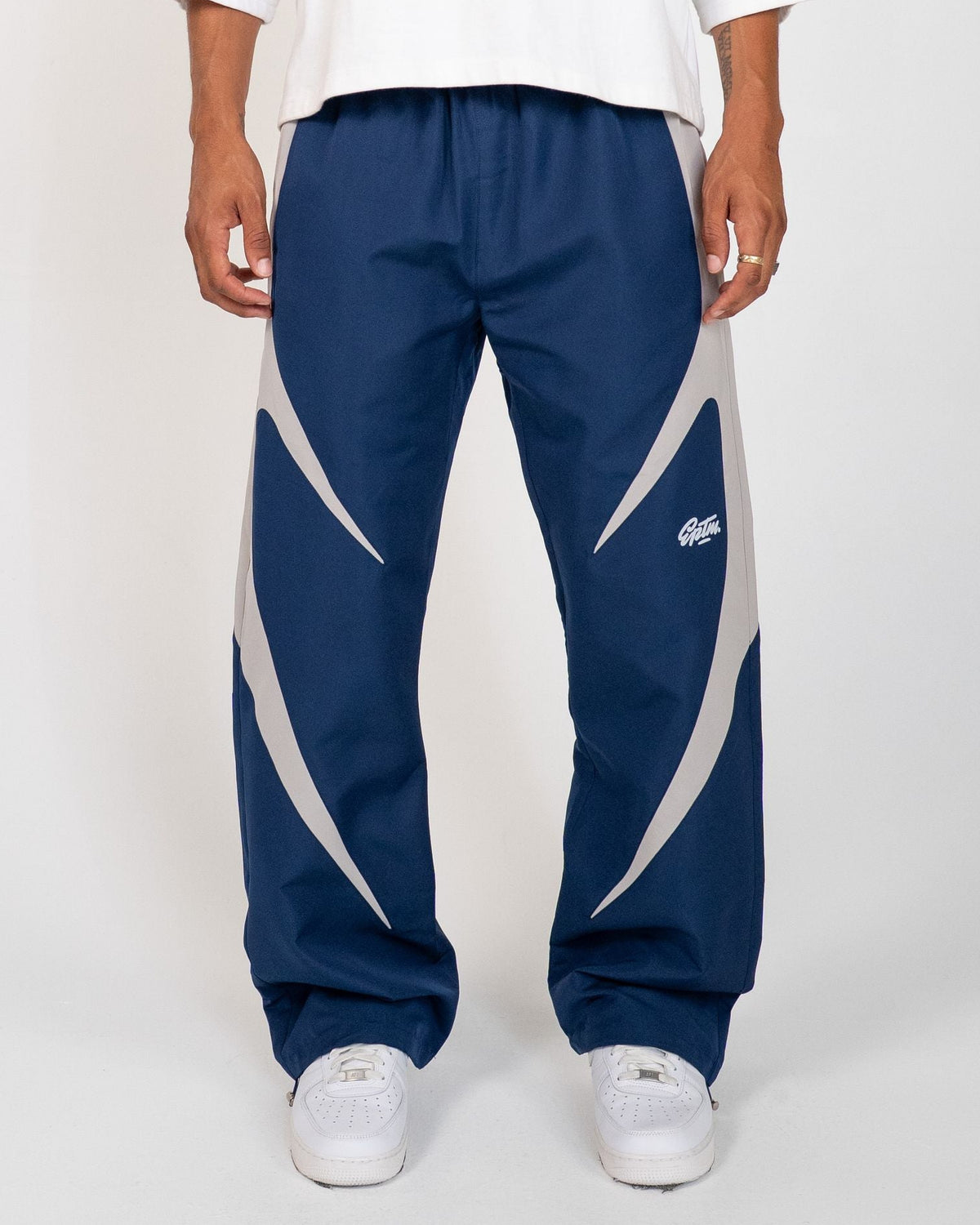 Navy Blue Blade Men's Reflective Pants, navy wide-leg with light gray blade panels, front view on model