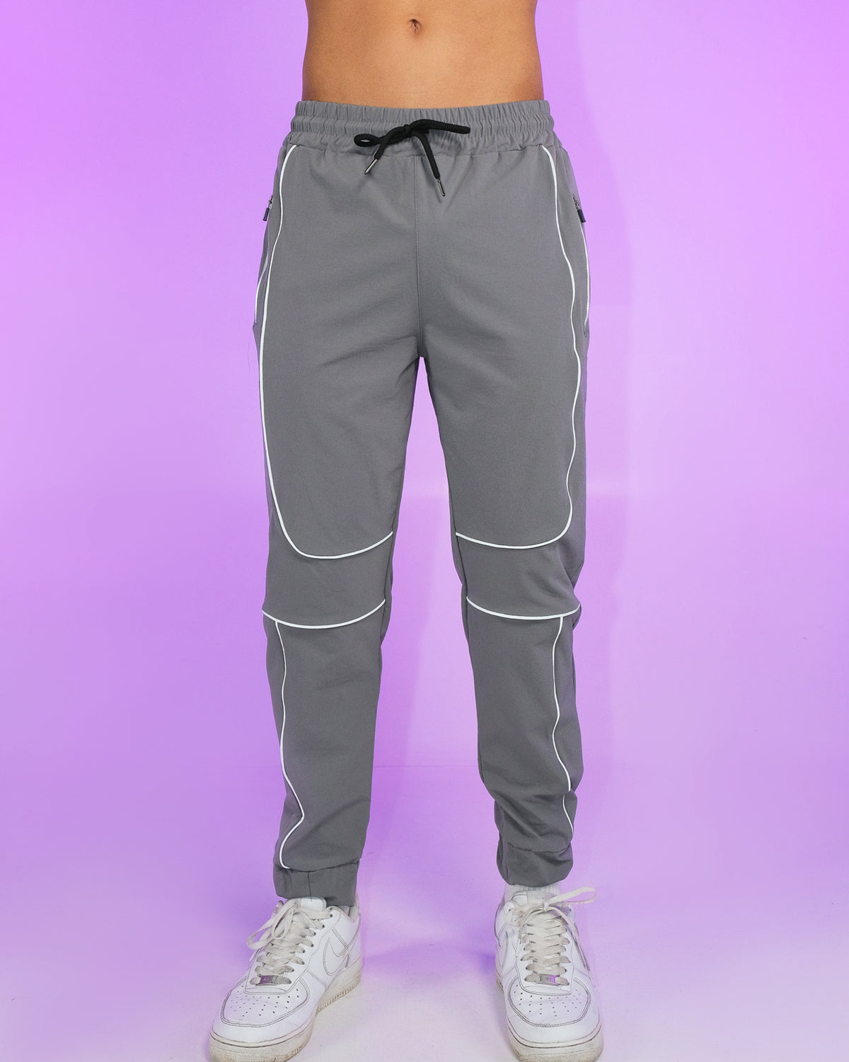 Gray reflective joggers with reflective leg panels, elastic waist and drawstring.
