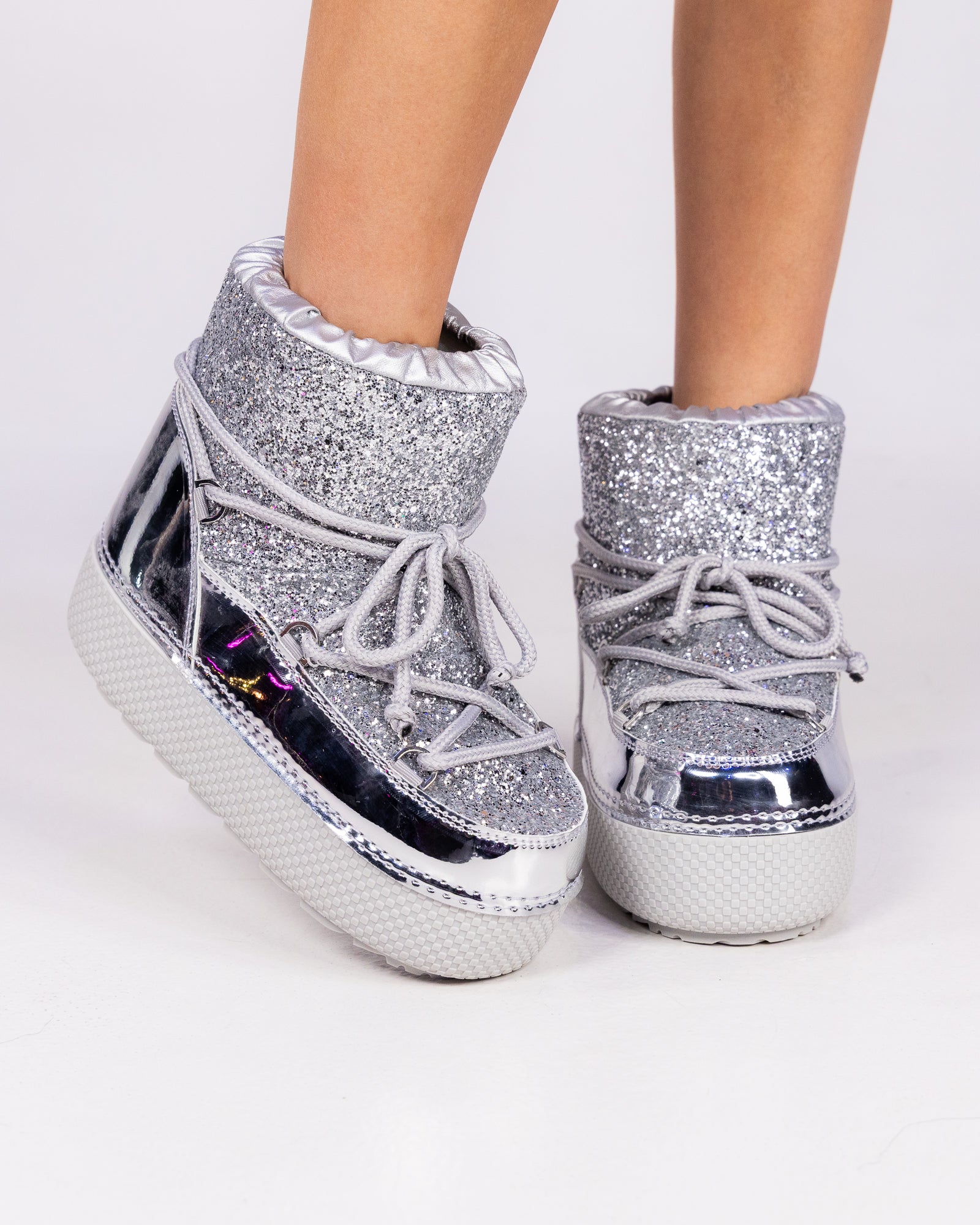 Silver glitter winter booties with lace-up front, ruffle cuff, and platform sole