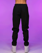 Black unisex joggers with drawstring waist, tapered legs, and elastic ankle cuffs