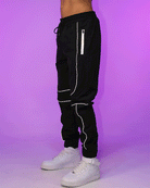 Black jogger pants with reflective side stripe, drawstring waist and tapered ankle cuffs