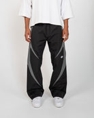 Black Blade Men's Reflective Pants, black wide-leg with gray blade panels, front view on model