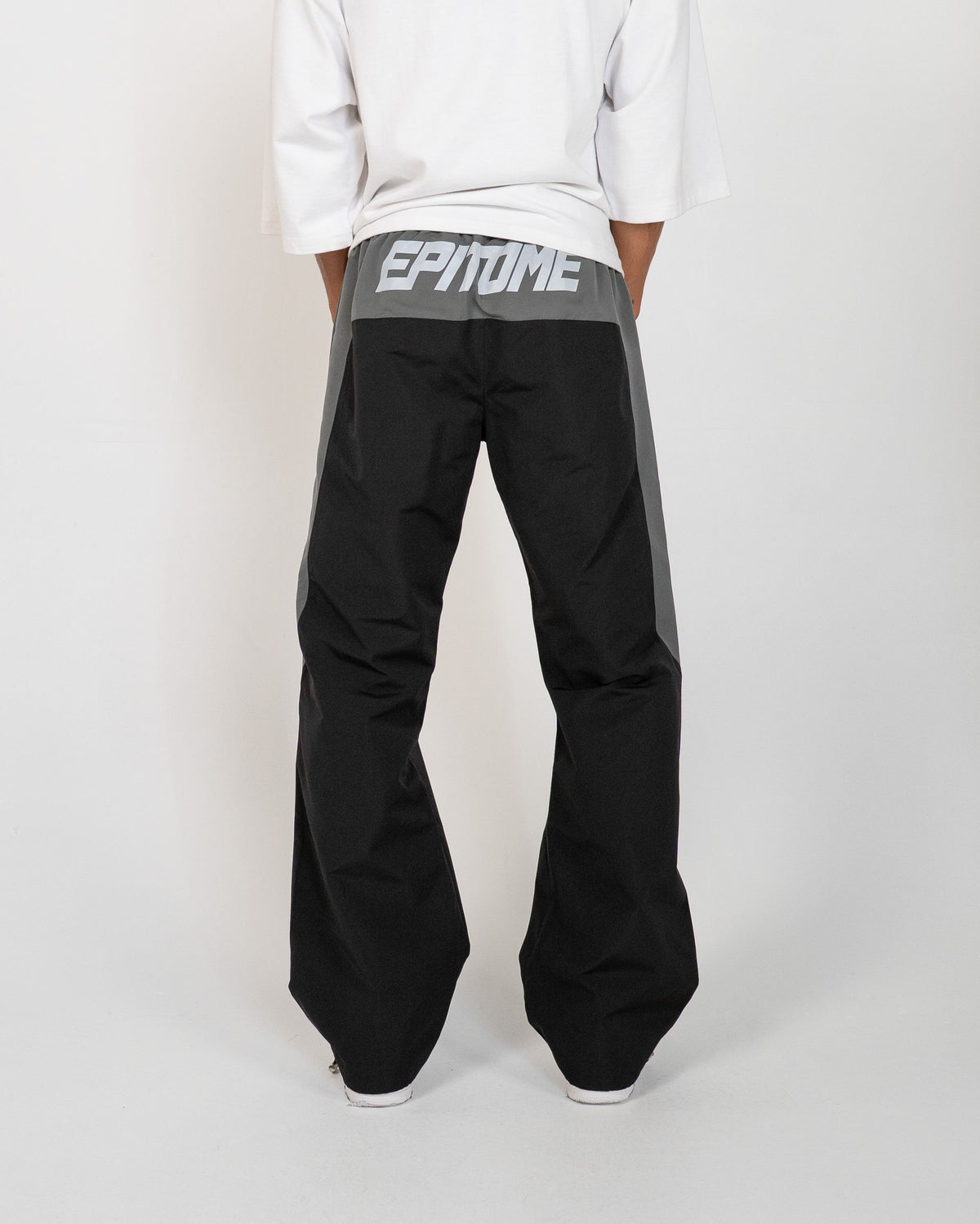 Black Blade Men's Reflective Pants, back view on model with gray EPITOME waistband panel