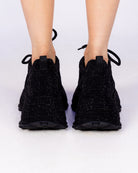 Black Crystal rhinestone wedge sneakers, all-black sparkle, back view on feet