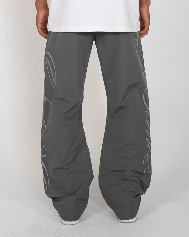 Charcoal Monogram Men's Pants, gray wide-leg with script monogram, back view on model