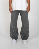Charcoal Monogram Men's Pants, gray wide-leg with script monogram down the legs, front view on model