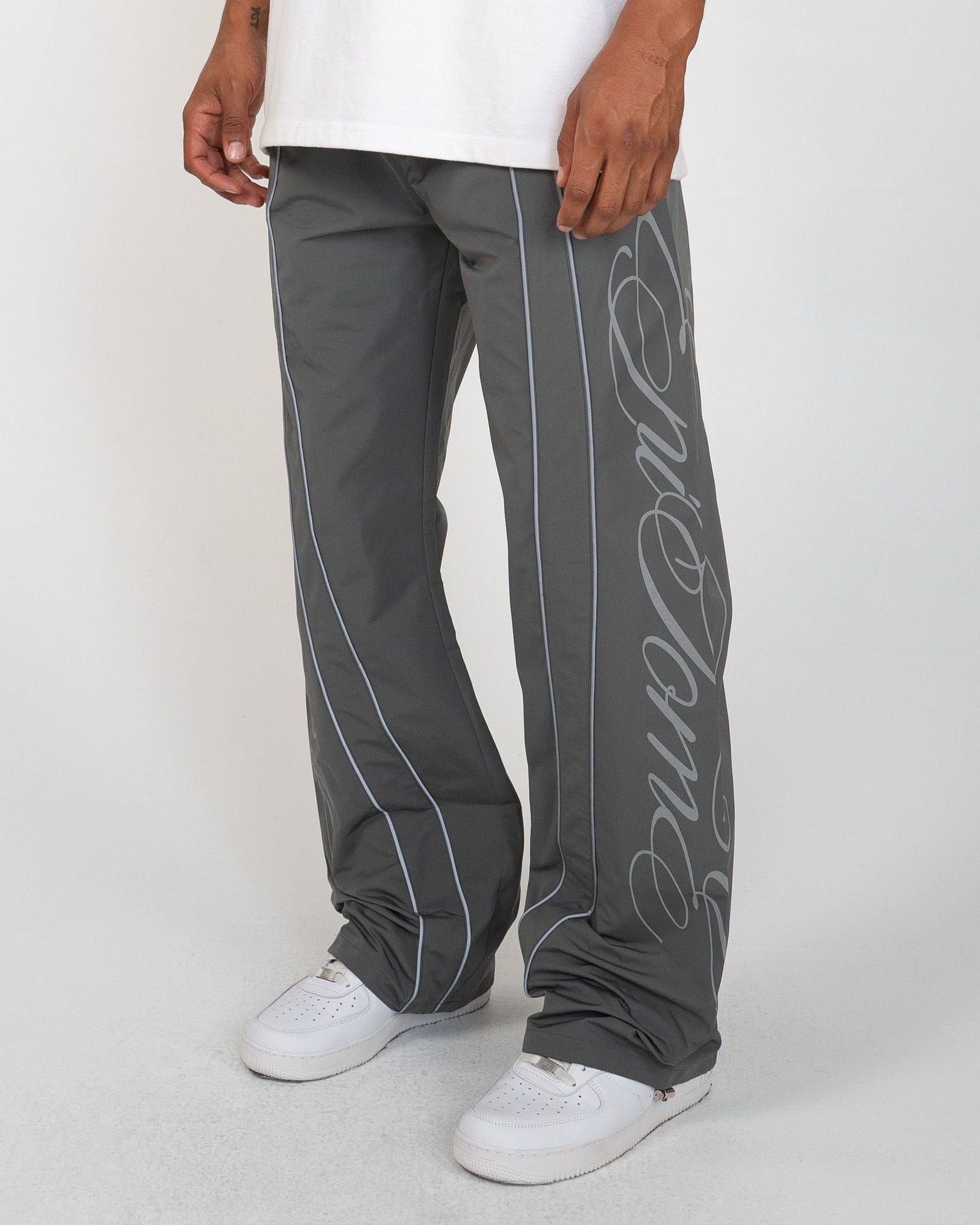 Charcoal Monogram Men's Pants, gray wide-leg with silver script monogram and piping, front view on model