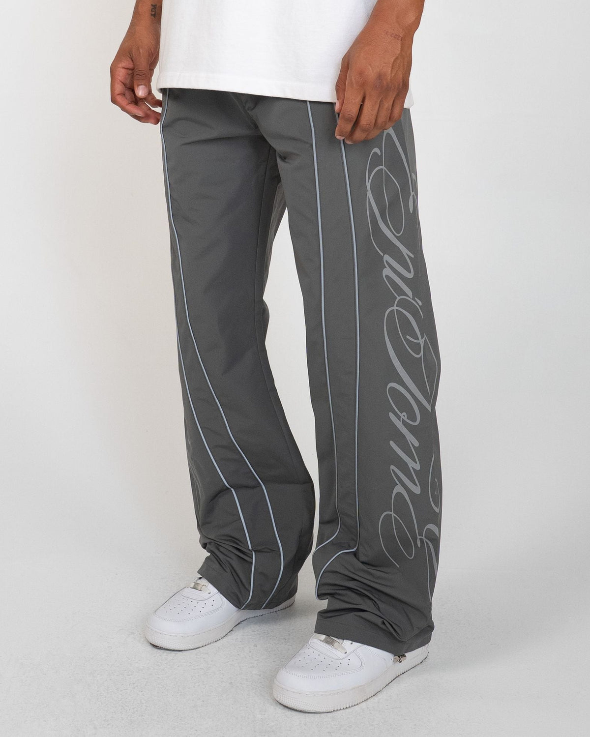 Charcoal Monogram Men's Pants, gray wide-leg with silver script monogram and piping, front view on model