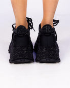 Midnight Sky black rhinestone wedge sneakers, back view on feet