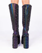 Milky Way reflective chunky platform knee-high boots, back view with studded heels