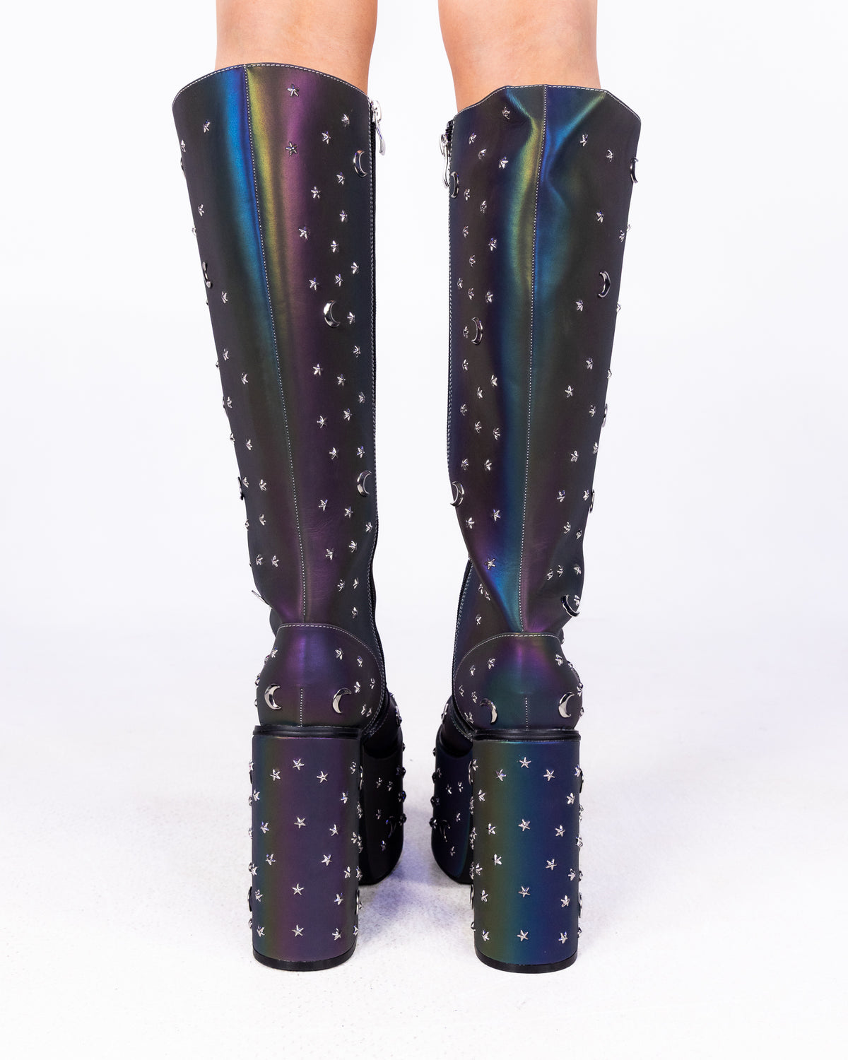 Milky Way reflective chunky platform knee-high boots, back view with studded heels