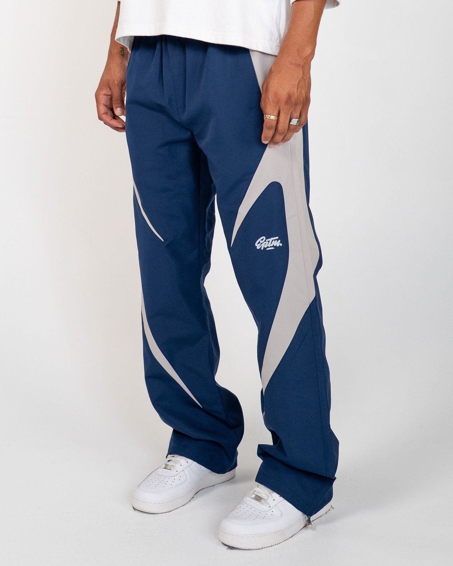 Navy Blue Blade Men's Reflective Pants, navy wide-leg with light gray blade panels, angled view on model