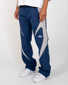 Navy Blue Blade Men's Reflective Pants, navy wide-leg with light gray blade panels, angled view on model