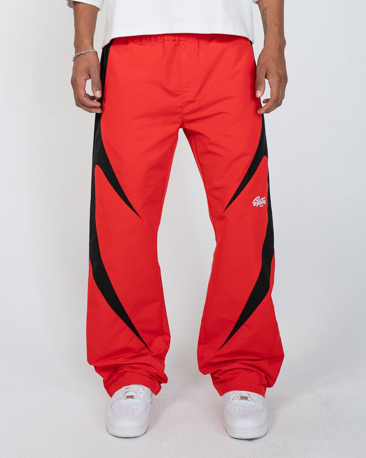Red Blade Men's Pants, red wide-leg with black blade panels, front view on model