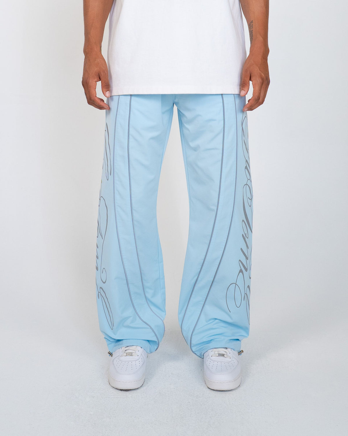 Sky Blue Monogram Men's Pants, light blue wide-leg with script monogram, front view on model