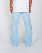 Sky Blue Monogram Men's Pants, light blue wide-leg with script monogram, back view on model