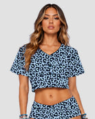 Feral Feline Blue Leopard Cropped Jersey, V-neck button-front crop top, close-up front view on model